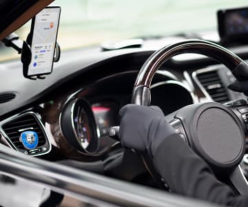 Car driver with taxi app on mobile