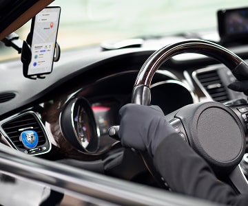 Car driver with taxi app on mobile